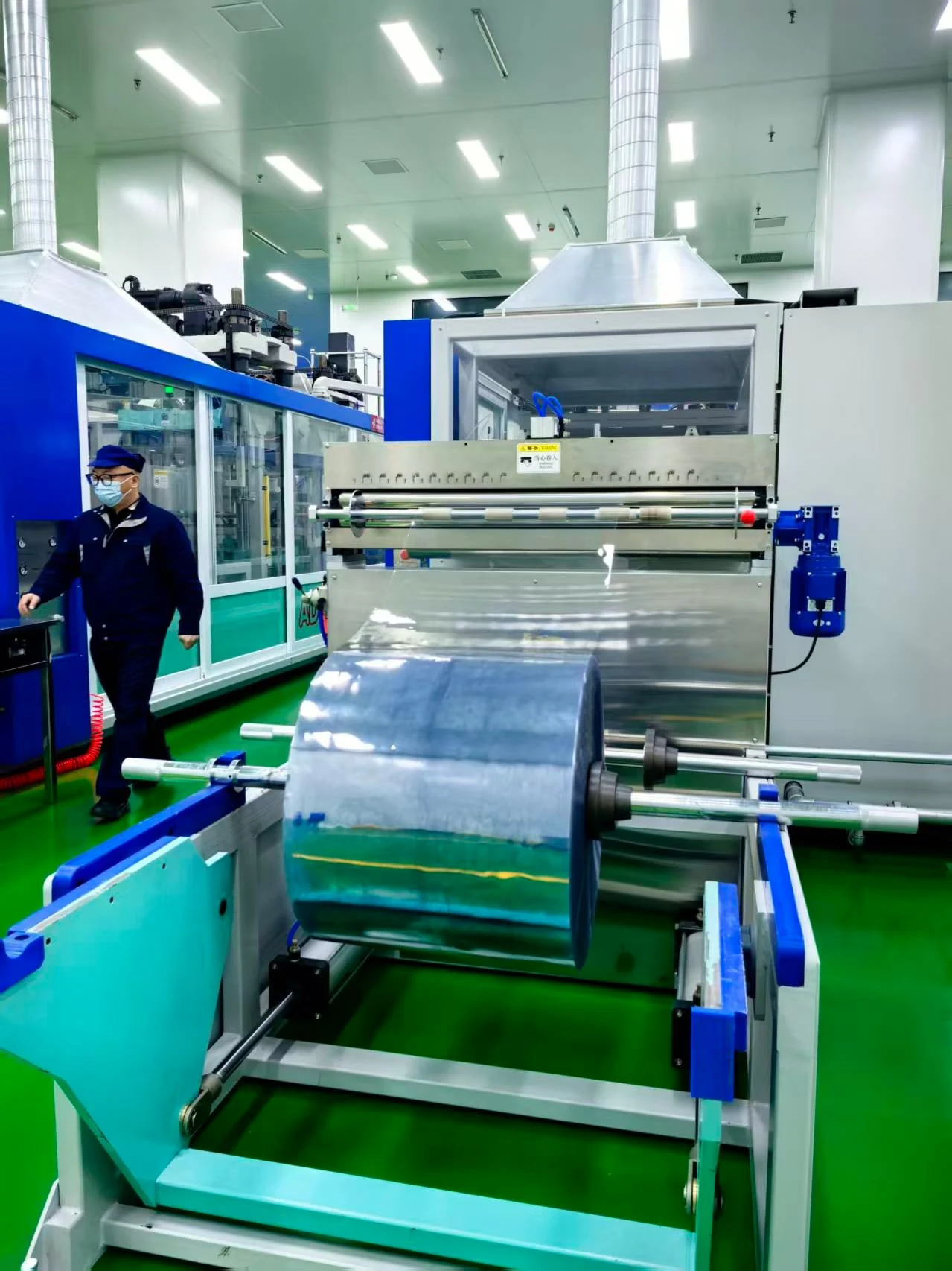 Standardized hygienic operator feeding polymer sheet into automated line